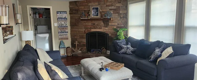 a living room with furniture and a fireplace