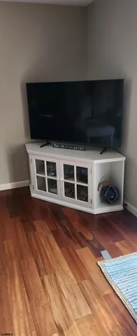 a living room with a flat screen tv and rug