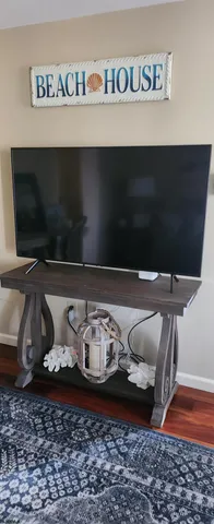 a living room with furniture and flat screen tv
