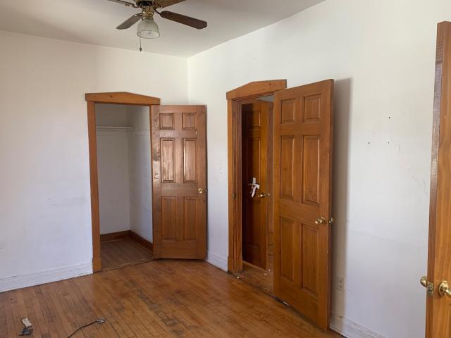 820 Elgin Avenue Forest Park, IL 60130 - Photo 20 of 20 an empty room with wooden floor closet and windows