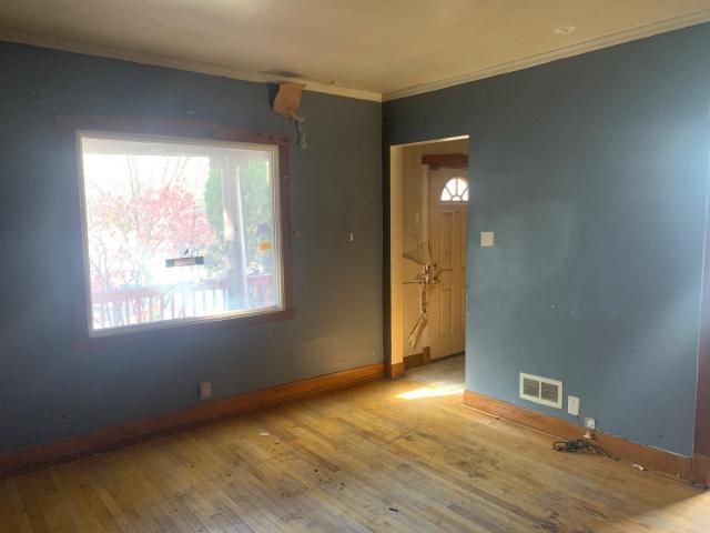 820 Elgin Avenue Forest Park, IL 60130 - Photo 5 of 20 a view of an empty room with wooden floor and a window