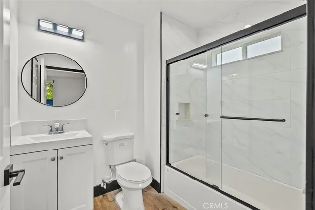 a bathroom with a toilet sink and a mirror