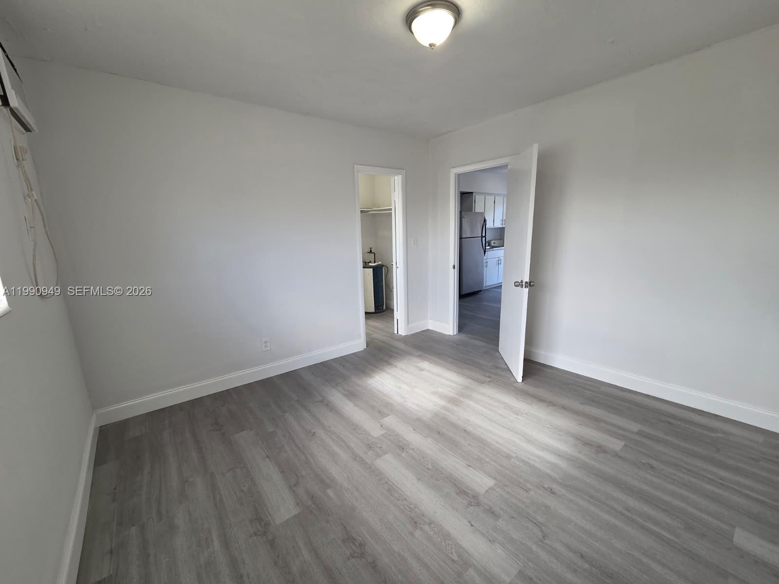 1628 Southwest 7th Street, Unit 8 Miami, FL 33135 - Photo 4 of 8 a view of an empty room with wooden floor and closet