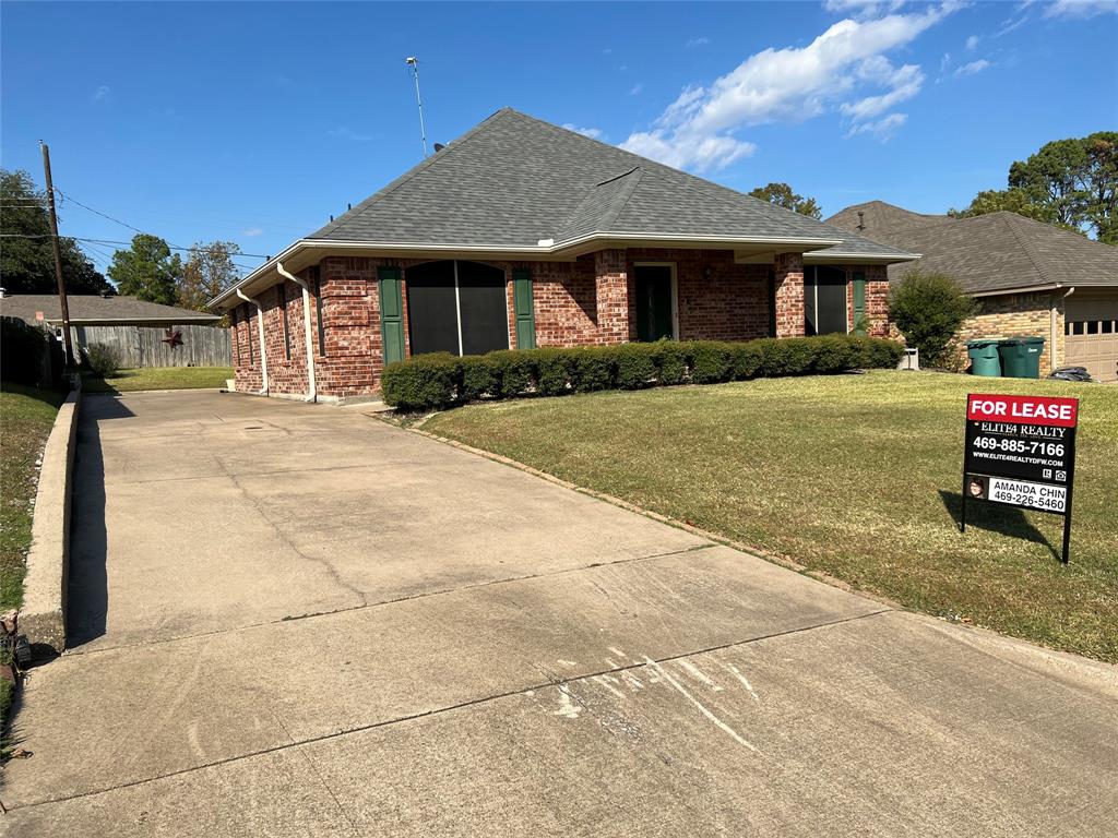 1825 Glenway Drive Sherman, TX 75092 - Photo 1 of 21 a front view of a house with a garden