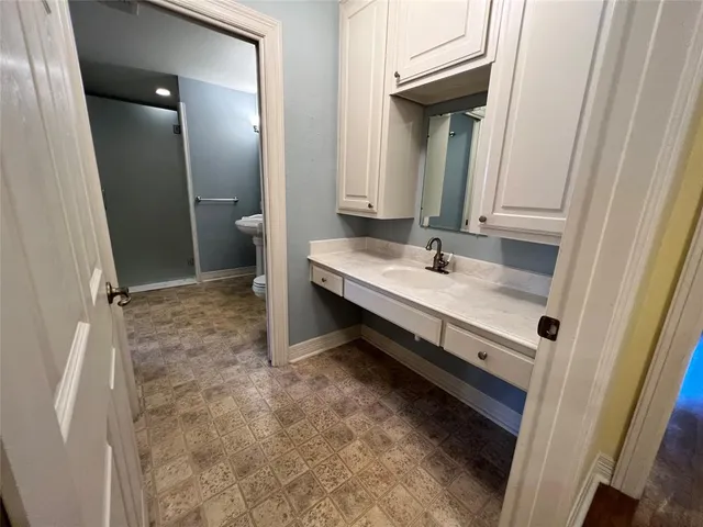 a bathroom with a sink a mirror and a shower