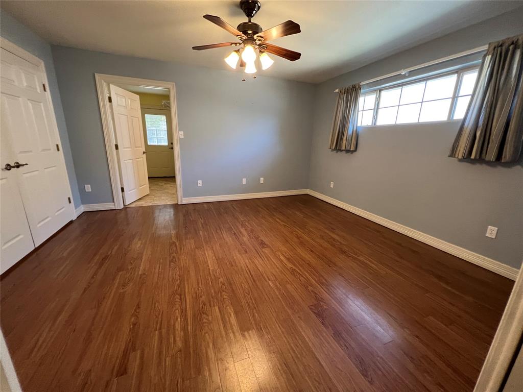 1825 Glenway Drive Sherman, TX 75092 - Photo 14 of 21 a view of an empty room with wooden floor and a window