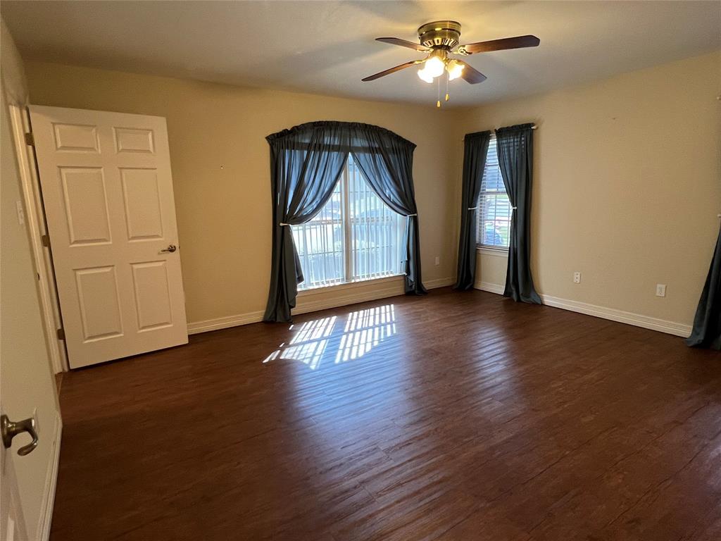 1825 Glenway Drive Sherman, TX 75092 - Photo 4 of 21 a view of an empty room with window and wooden floor