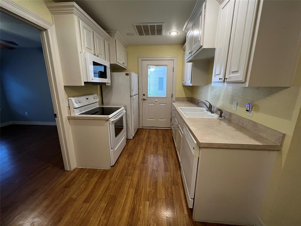 1825 Glenway Drive Sherman, TX 75092 - Photo 6 of 21 a kitchen with a sink a stove and cabinets