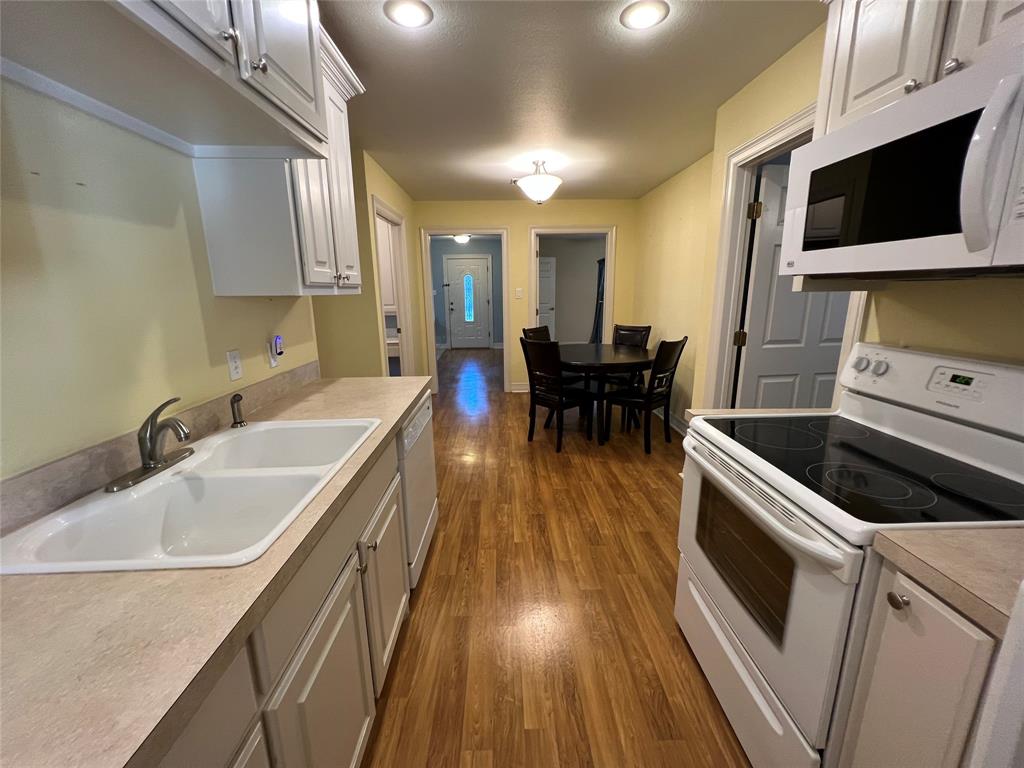 1825 Glenway Drive Sherman, TX 75092 - Photo 7 of 21 a kitchen with a sink and wooden floor