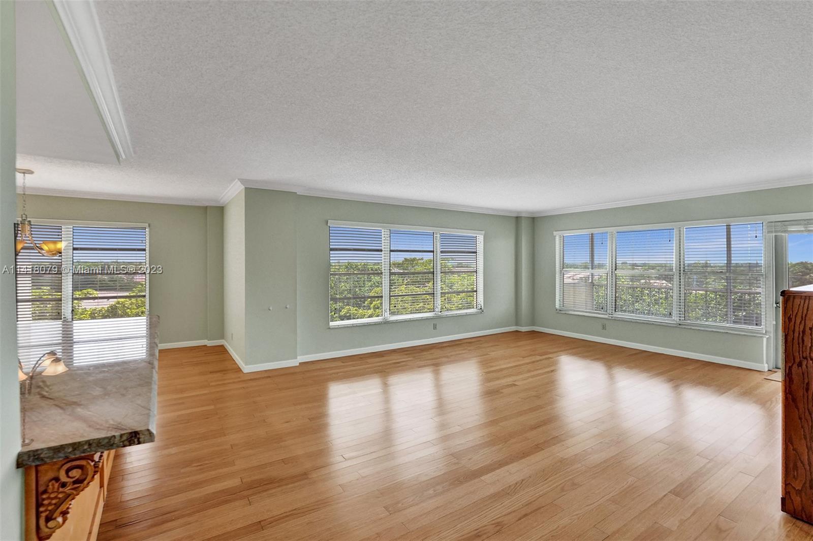 10777 West Sample Road, Unit 614 Coral Springs, FL 33065 - Photo 11 of 40 a view of empty room with wooden floor and fan