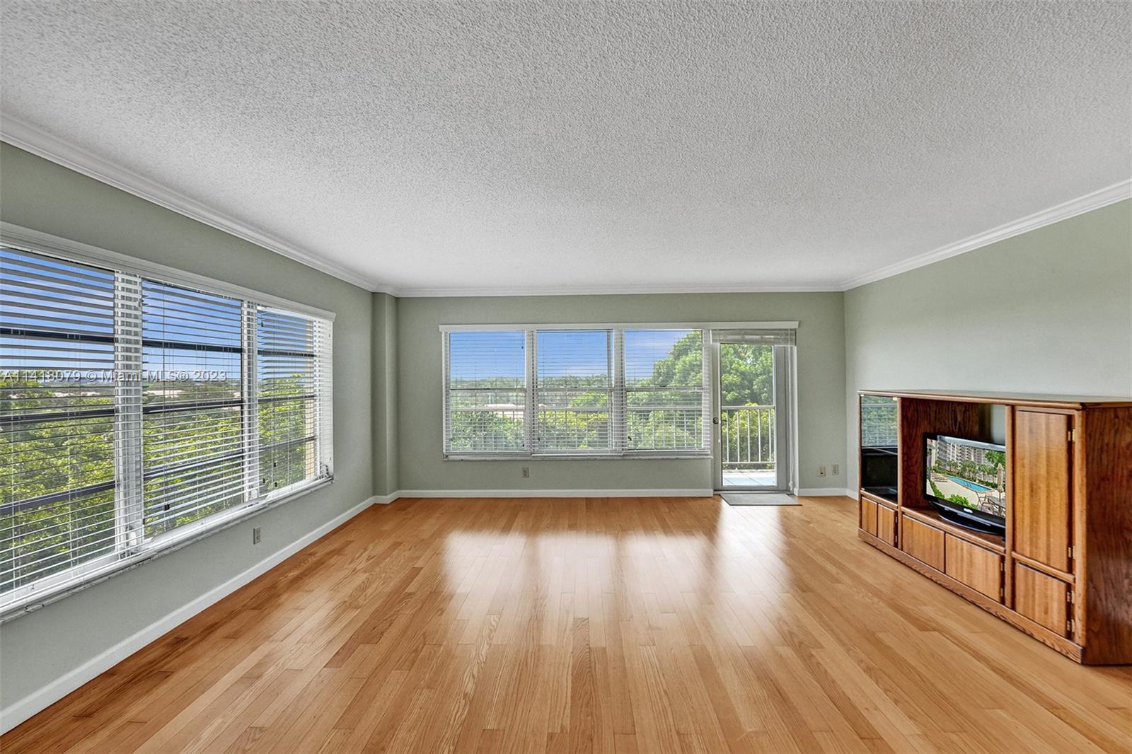 10777 West Sample Road, Unit 614 Coral Springs, FL 33065 - Photo 12 of 40 a view of empty room with wooden floor and fireplace