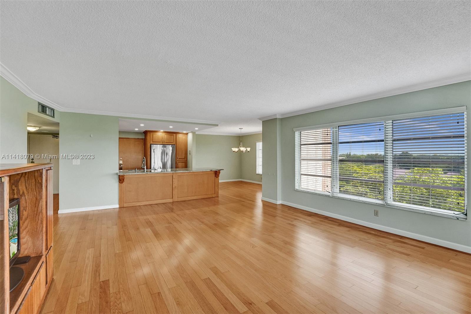10777 West Sample Road, Unit 614 Coral Springs, FL 33065 - Photo 13 of 40 wooden floor in an empty room with a window
