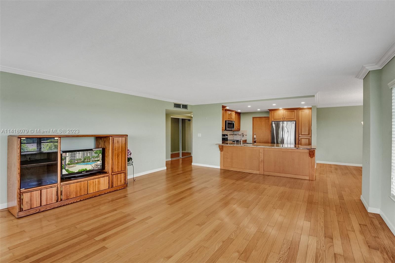 10777 West Sample Road, Unit 614 Coral Springs, FL 33065 - Photo 14 of 40 a view of empty room with wooden floor and fireplace