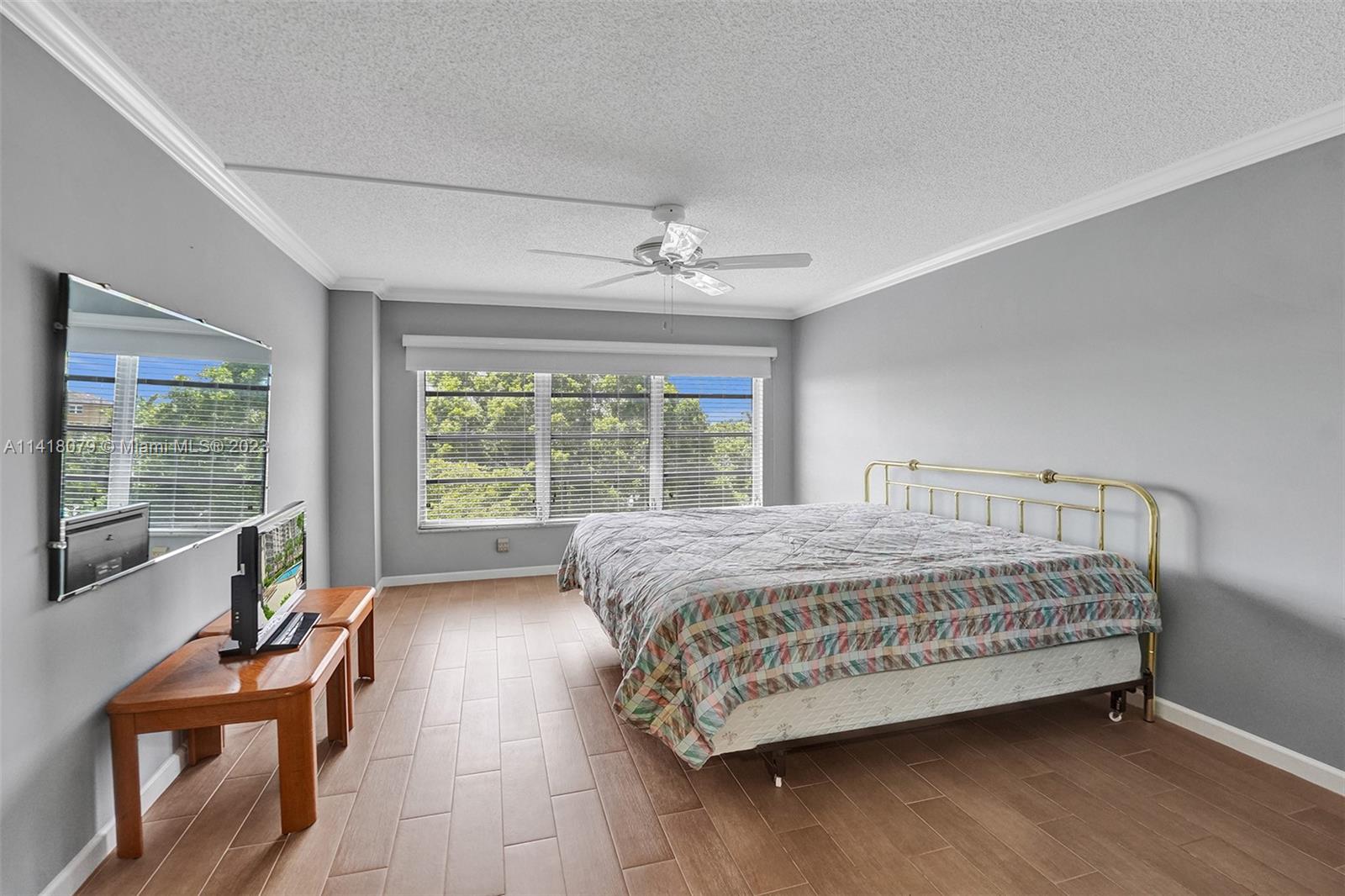10777 West Sample Road, Unit 614 Coral Springs, FL 33065 - Photo 24 of 40 a bed sitting in a bedroom next to a window