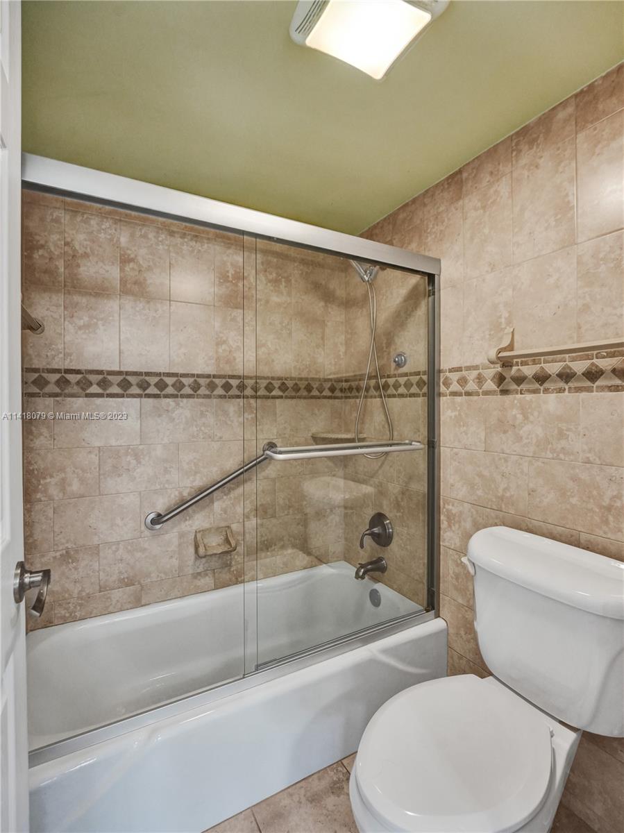 10777 West Sample Road, Unit 614 Coral Springs, FL 33065 - Photo 27 of 40 a bathroom with a toilet and a shower