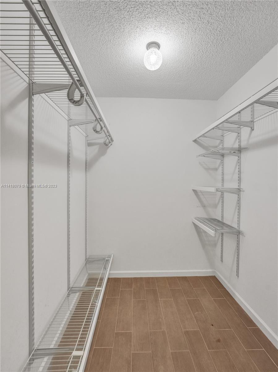 10777 West Sample Road, Unit 614 Coral Springs, FL 33065 - Photo 28 of 40 a view of an empty walk in closet