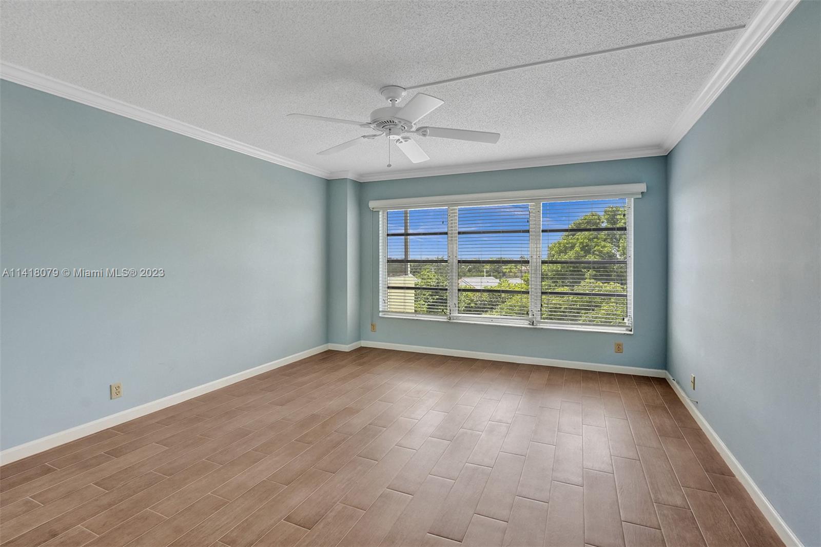 10777 West Sample Road, Unit 614 Coral Springs, FL 33065 - Photo 30 of 40 wooden floor in an empty room with a window