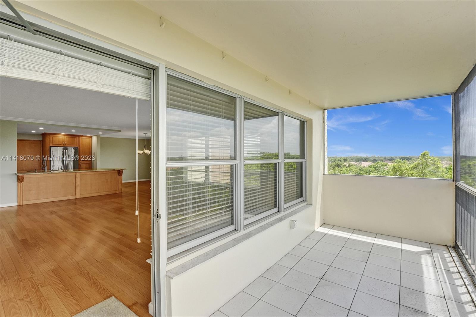 10777 West Sample Road, Unit 614 Coral Springs, FL 33065 - Photo 36 of 40 a view of an empty room with wooden floor and a window