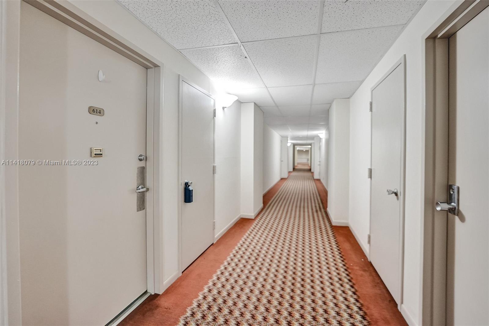 10777 West Sample Road, Unit 614 Coral Springs, FL 33065 - Photo 9 of 40 a view of a hallway with wooden floor