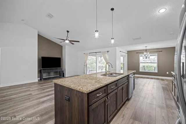a kitchen with granite countertop a stove and a sink