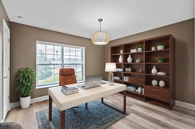 a view of a room with wooden floor gym equipment and a window