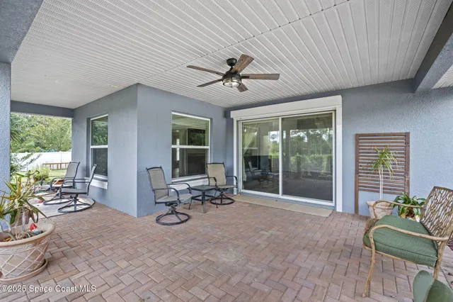 a view of a patio with table and chairs