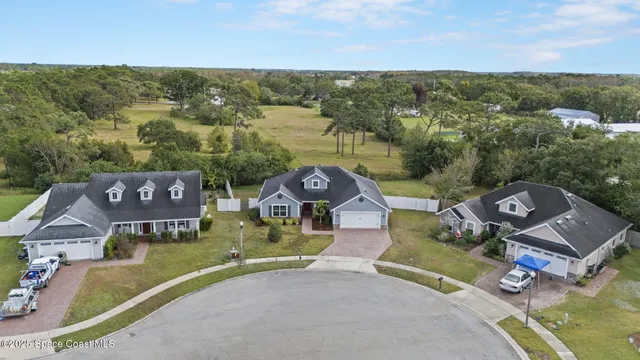 an aerial view of a house with a lake view