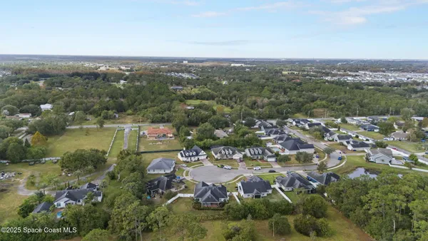an aerial view of residential house with outdoor space and swimming pool