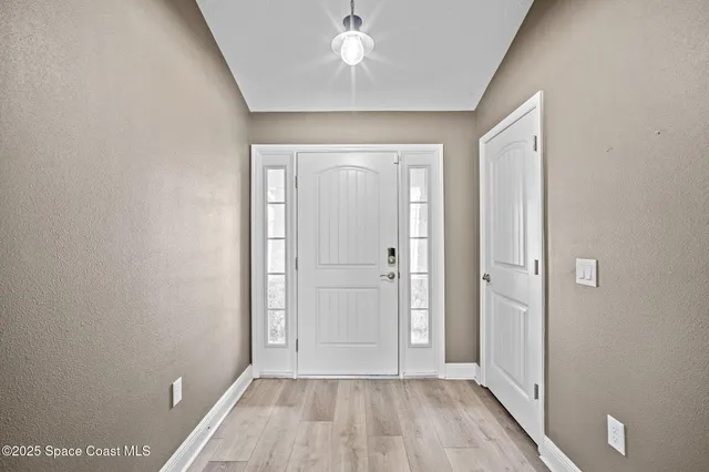 a living room with furniture a large window and a table