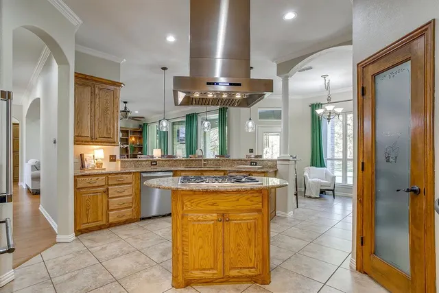 a kitchen with stainless steel appliances granite countertop a stove a sink and a refrigerator