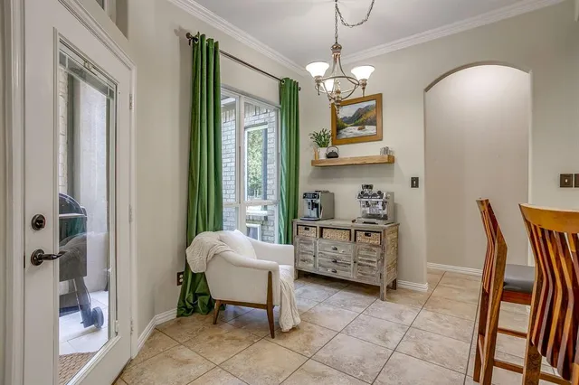 a spacious bedroom with a bed and a chandelier