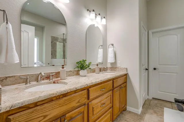 a bathroom with a tub sink and mirror