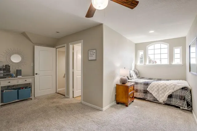 a bedroom with bed and a chandelier