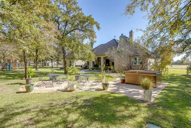 a view of a house with backyard porch and sitting area