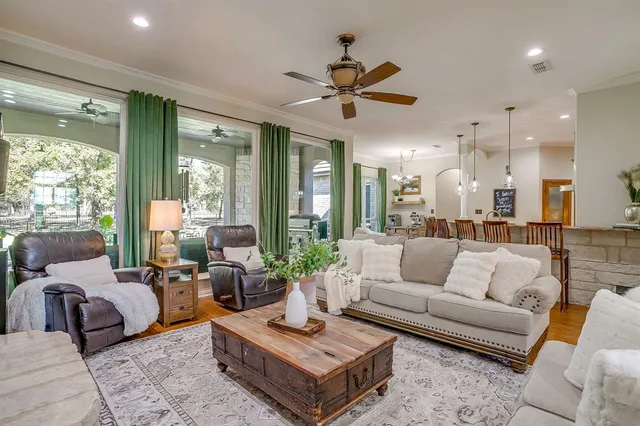 a living room with furniture a fireplace and a flat screen tv