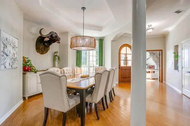 a view of a dining room with furniture wooden floor and chandelier
