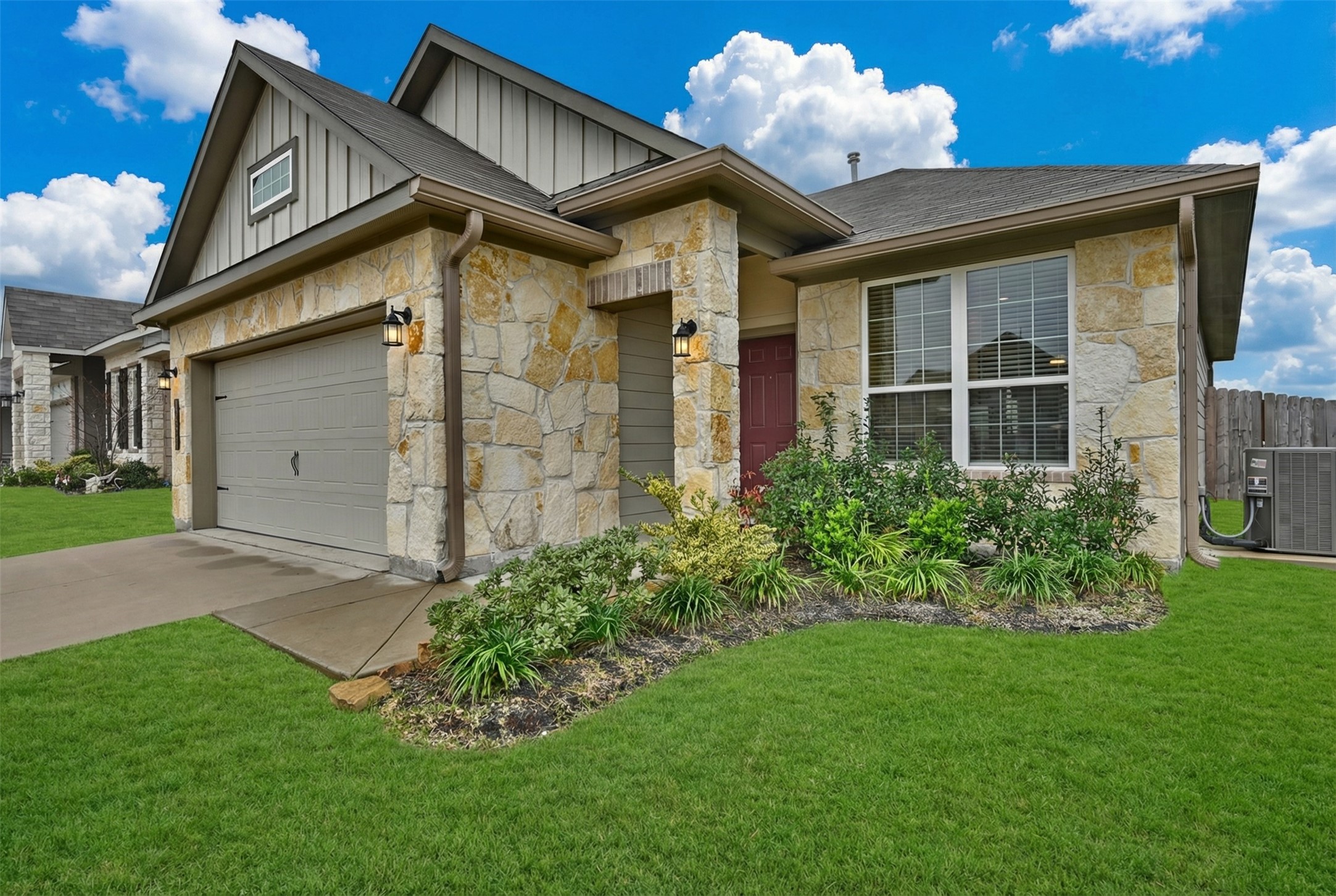 a front view of a house with a garden and plants