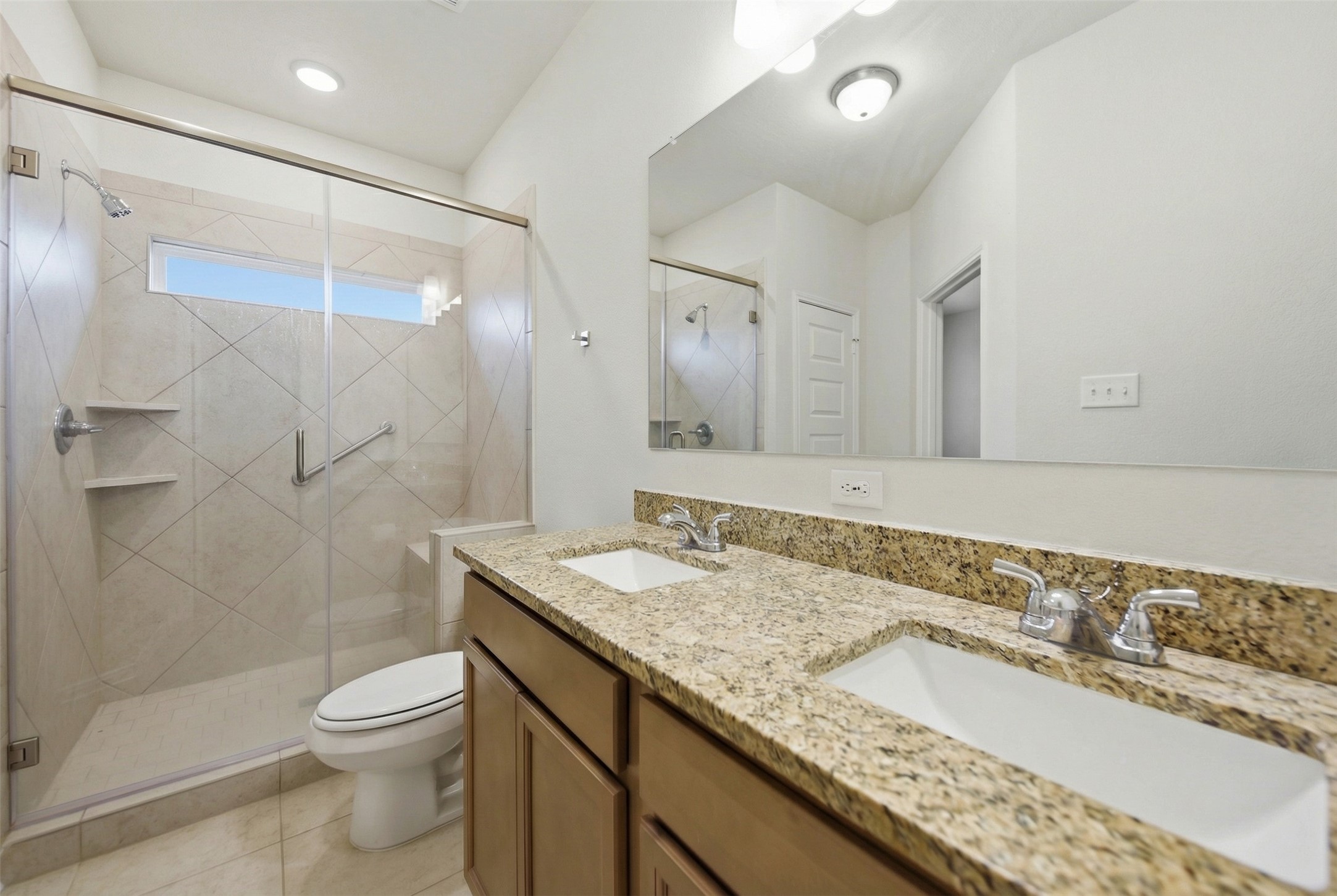 1443 Lk Rdg Drive Brenham, TX 77833 - Photo 17 of 17 a bathroom with a granite countertop sink a toilet a mirror and shower