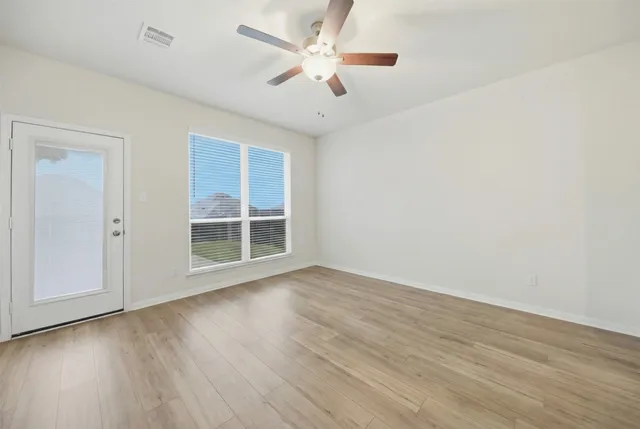 wooden floor in an empty room with a window