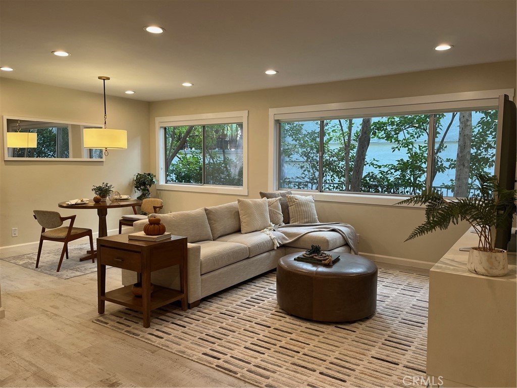 1025 North Kings Road, Unit 105 West Hollywood, CA 90069 - Photo 1 of 1 a living room with furniture and a large window