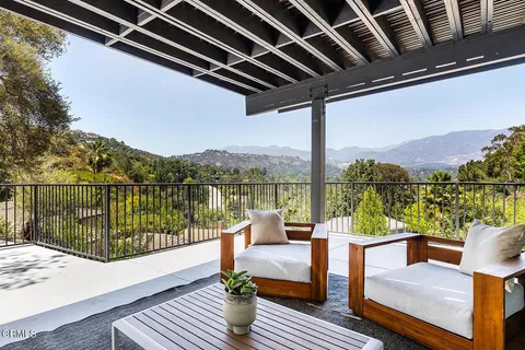 a view of a balcony with lake view and wooden floor