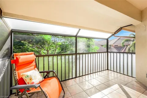 a bedroom with a bed wooden floor and window