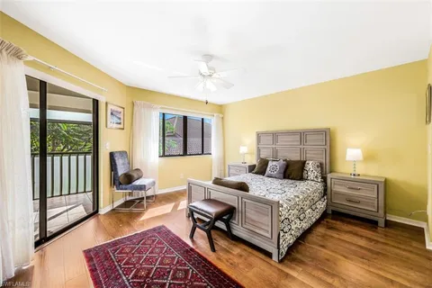 a bedroom with a bed and a dresser next to a window