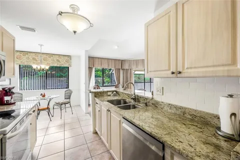 a kitchen with a sink and a stove top oven