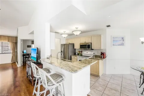 a view of a dining room kitchen and a wooden floor