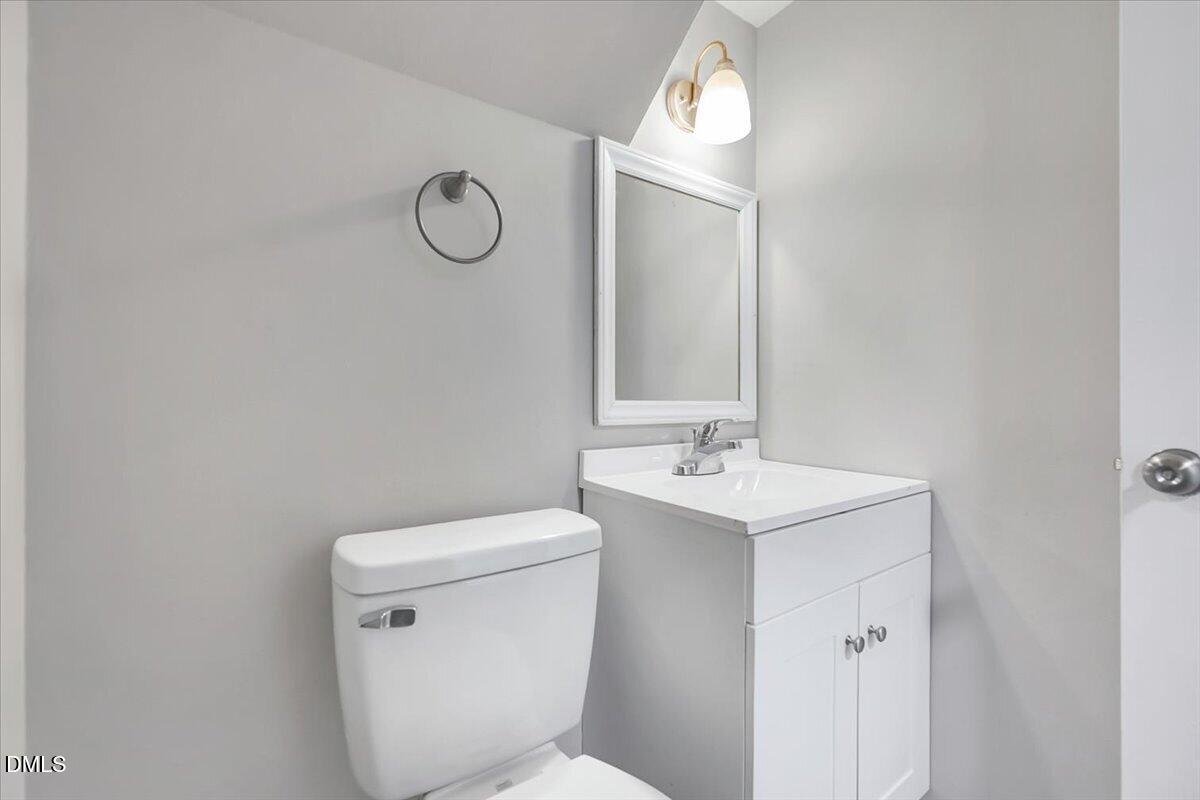 3408 Atlantic Avenue Raleigh, NC 27604 - Photo 27 of 48 a bathroom with a toilet sink vanity and mirror