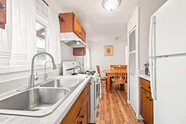 a kitchen with a sink cabinets and dining table