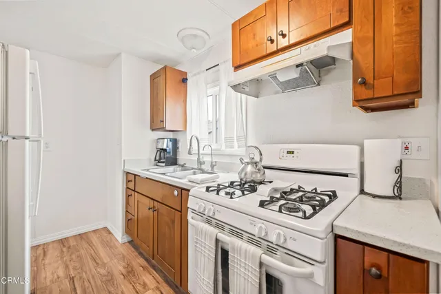 a kitchen with a stove a sink and a refrigerator