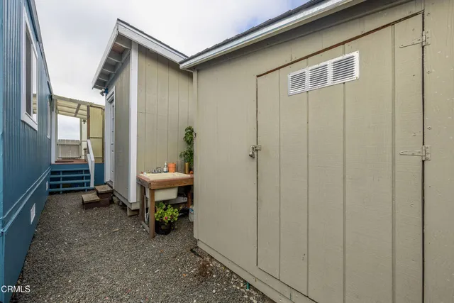 a view of a house with wooden fence