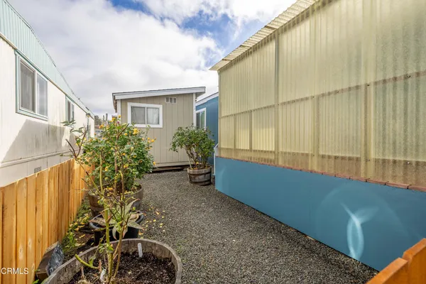 a view of a house with a backyard and sitting area